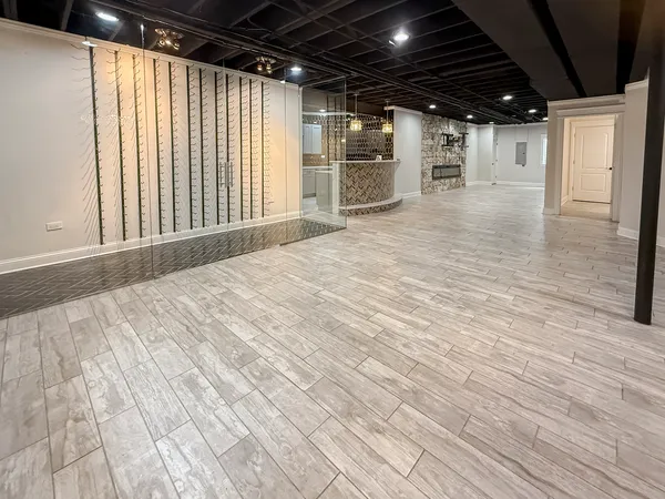 a view of an empty room with wooden floor