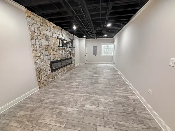 a view of empty room with wooden floor and fireplace