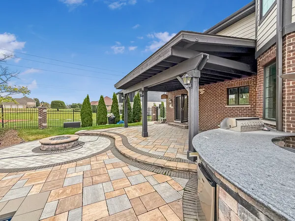 a view of a house with backyard and a patio
