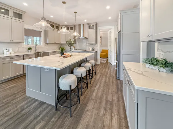 a large kitchen with a table and chairs in it