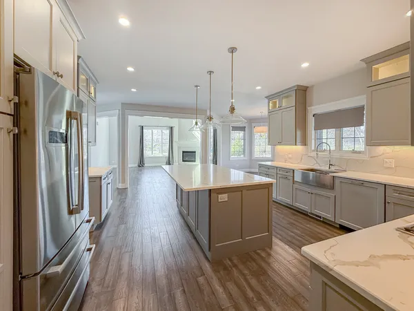 a large kitchen with stainless steel appliances kitchen island granite countertop a large counter top and stove