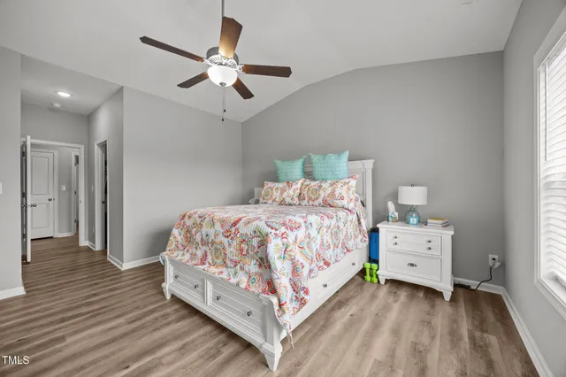 a bed room with a bed and a ceiling fan