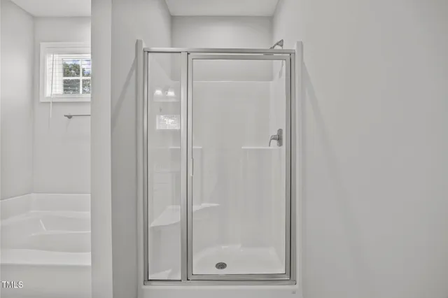 a bathroom with a glass shower door