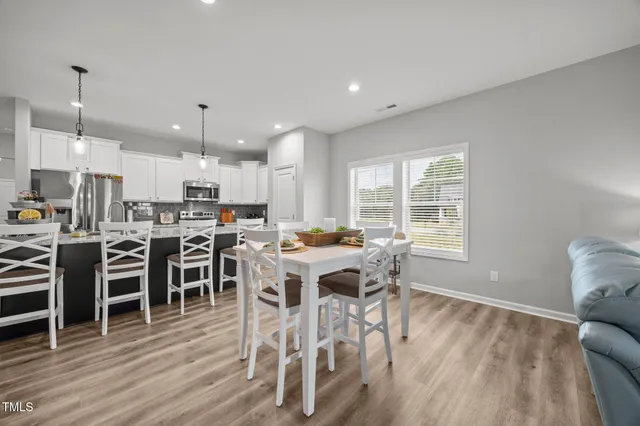a view of a dining room with furniture window and wooden floor