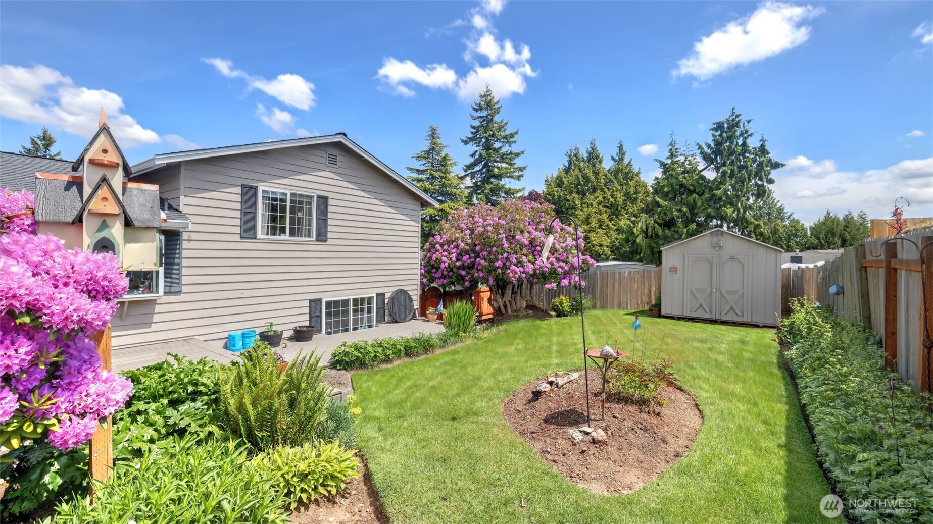 13735 Southeast 172nd Street Renton, WA 98058 - Photo 25 of 29 a front view of a house with a yard and garden