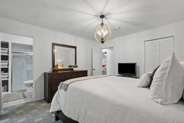 a bedroom with a bed and a dresser