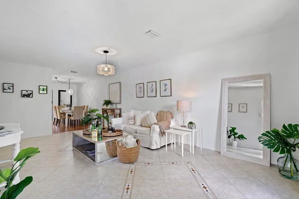 a living room with furniture potted plant and a table