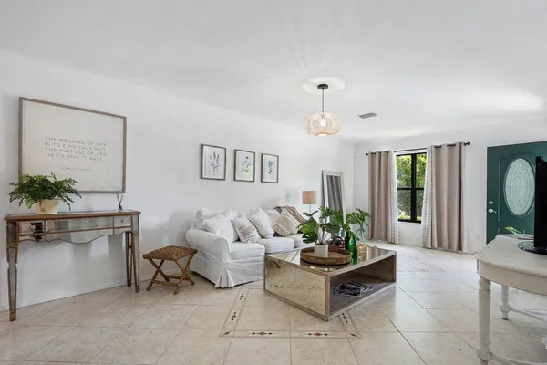 a living room with furniture potted plant and a window