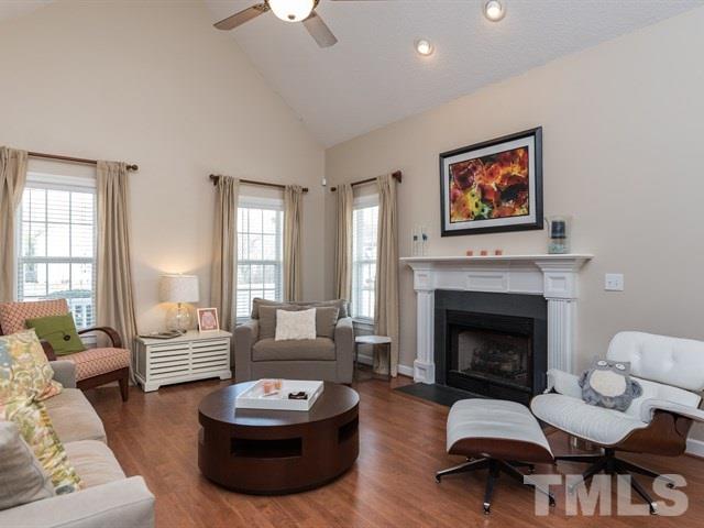 1232 Jogging Court Raleigh, NC 27603 - Photo 4 of 25 a living room with furniture a fireplace and a flat screen tv