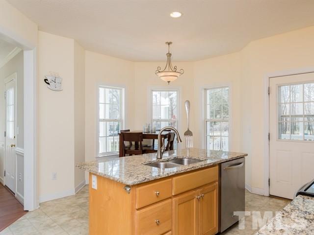 1232 Jogging Court Raleigh, NC 27603 - Photo 9 of 25 a kitchen with granite countertop a sink and cabinets
