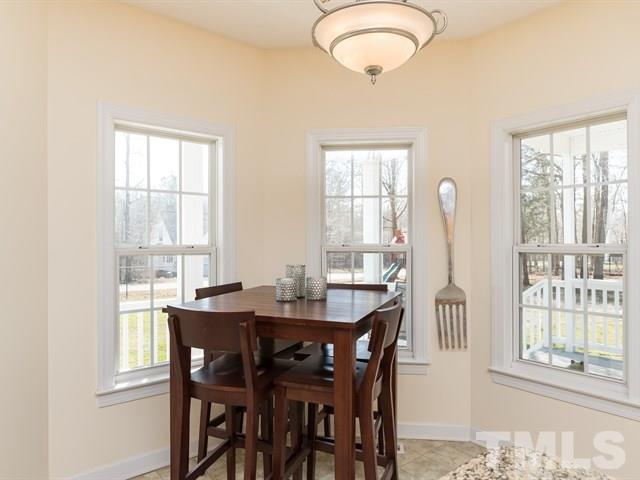 1232 Jogging Court Raleigh, NC 27603 - Photo 10 of 25 a dining room with furniture window and wooden floor