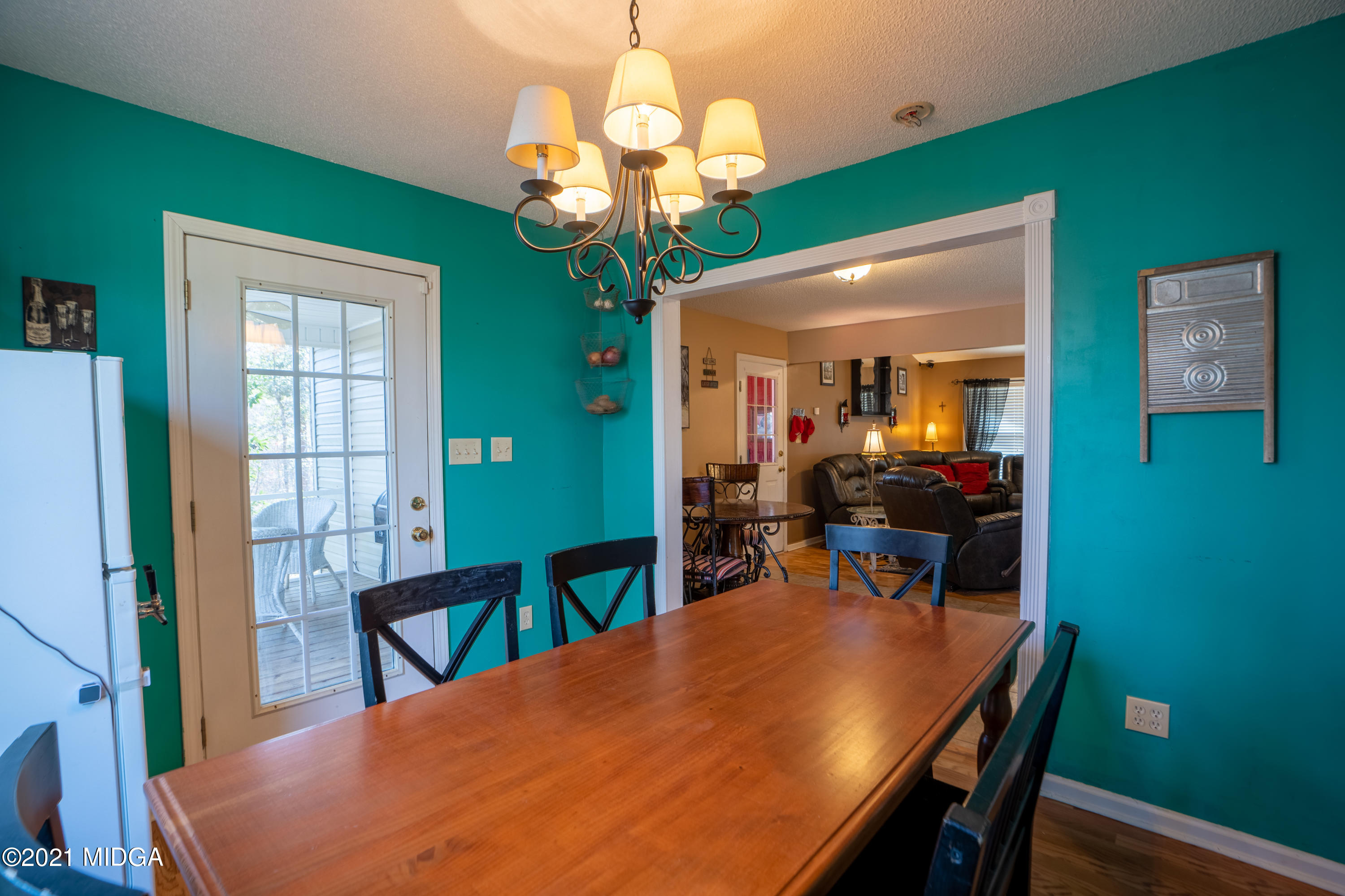 208 Camelot Road Gray, GA 31032 - Photo 11 of 41 a view of a dining room with furniture and a chandelier