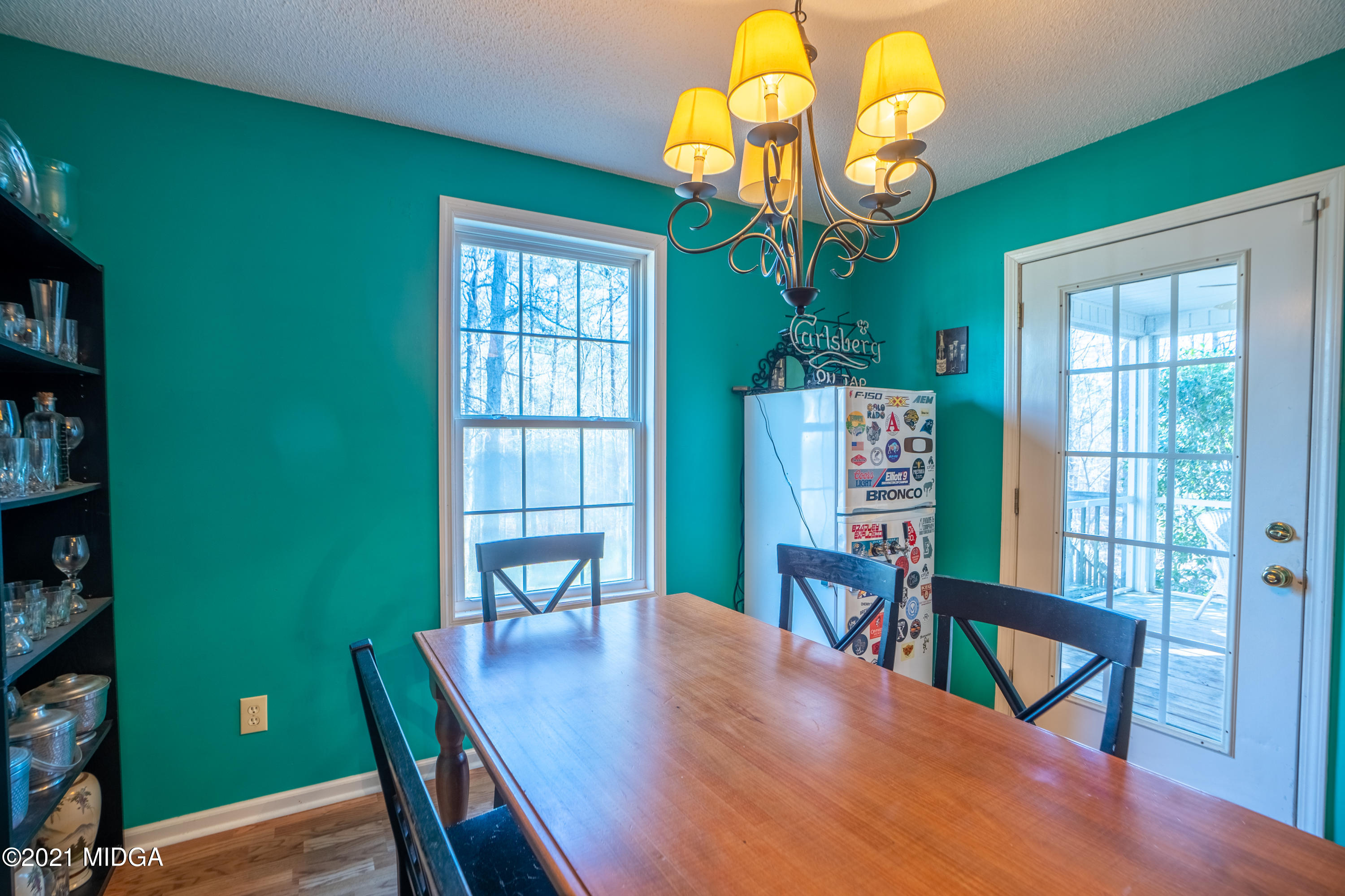 208 Camelot Road Gray, GA 31032 - Photo 12 of 41 a view of a dining room with furniture a chandelier and wooden floor