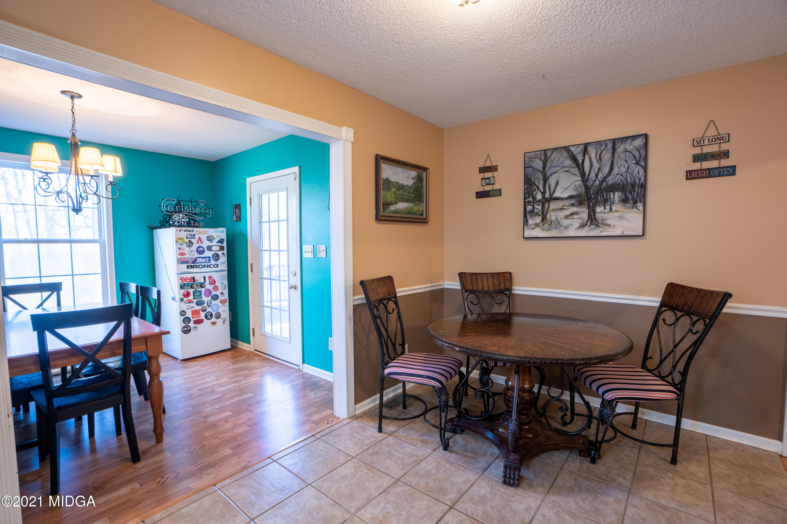 208 Camelot Road Gray, GA 31032 - Photo 13 of 41 a view of a dining room with furniture and chandelier