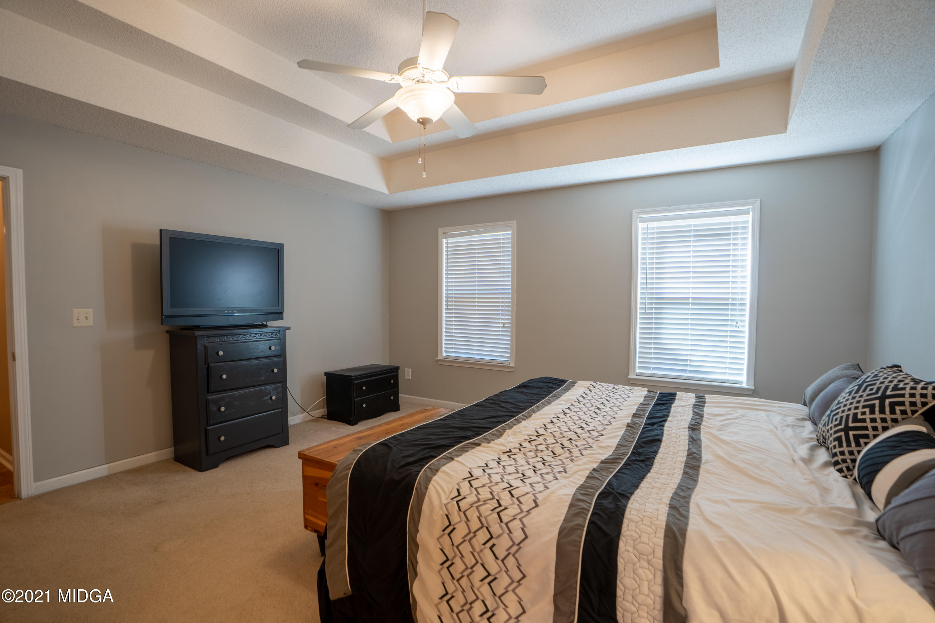 208 Camelot Road Gray, GA 31032 - Photo 14 of 41 a bedroom with a bed and a tv on the dresser