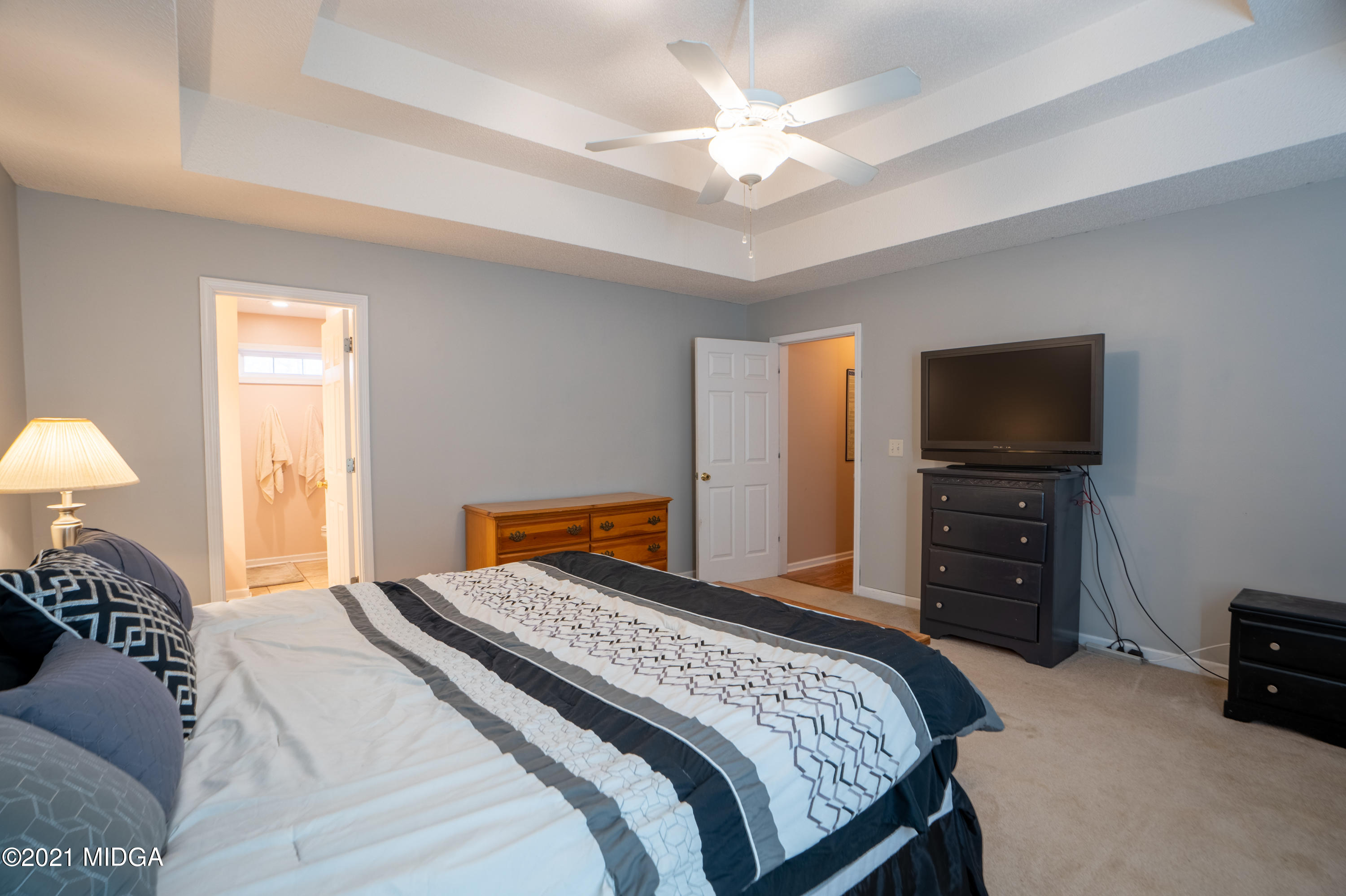 208 Camelot Road Gray, GA 31032 - Photo 15 of 41 a bedroom with a bed and a flat screen tv