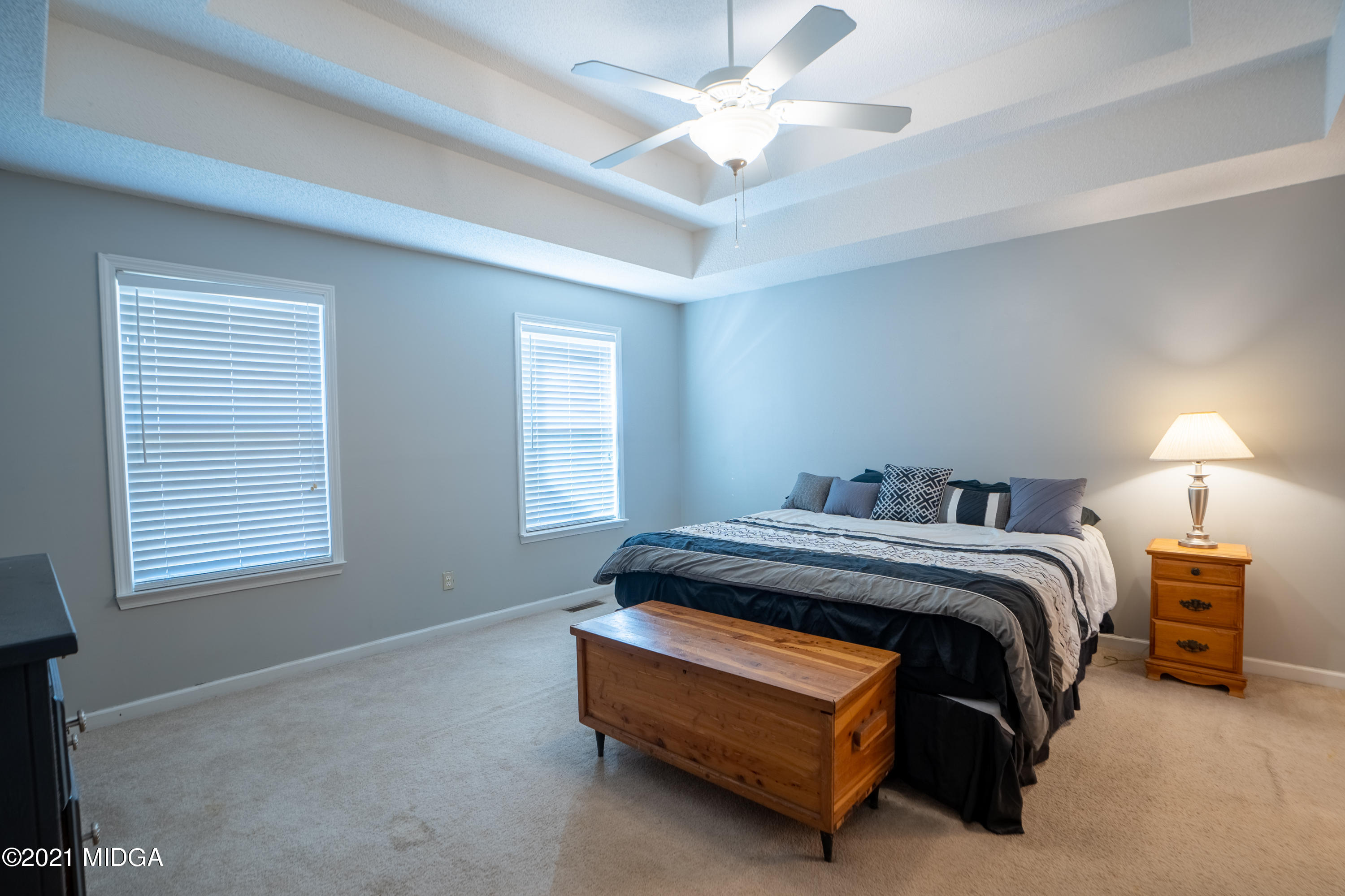 208 Camelot Road Gray, GA 31032 - Photo 17 of 41 a bed sitting in a bedroom next to a window and a chandelier