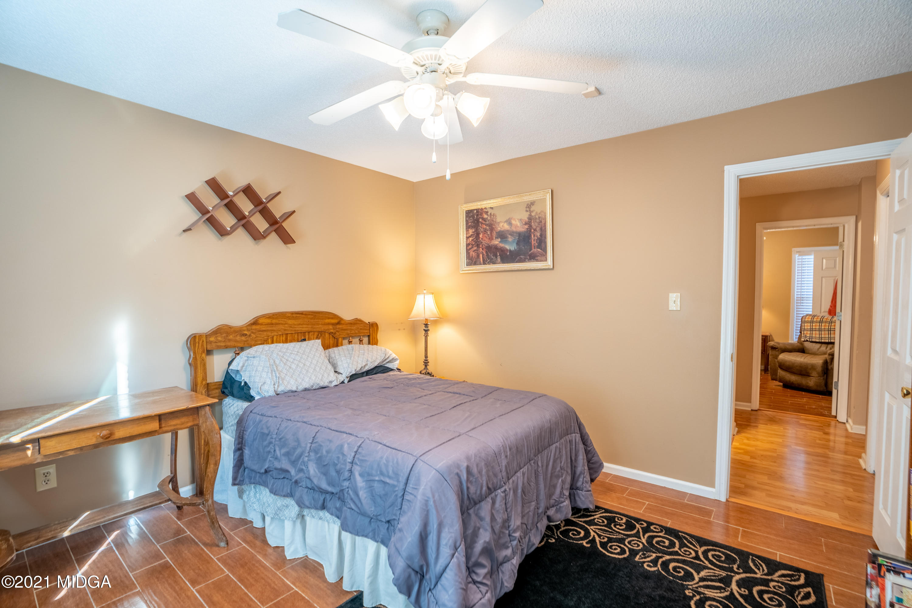 208 Camelot Road Gray, GA 31032 - Photo 23 of 41 a bedroom with a bed and a chandelier