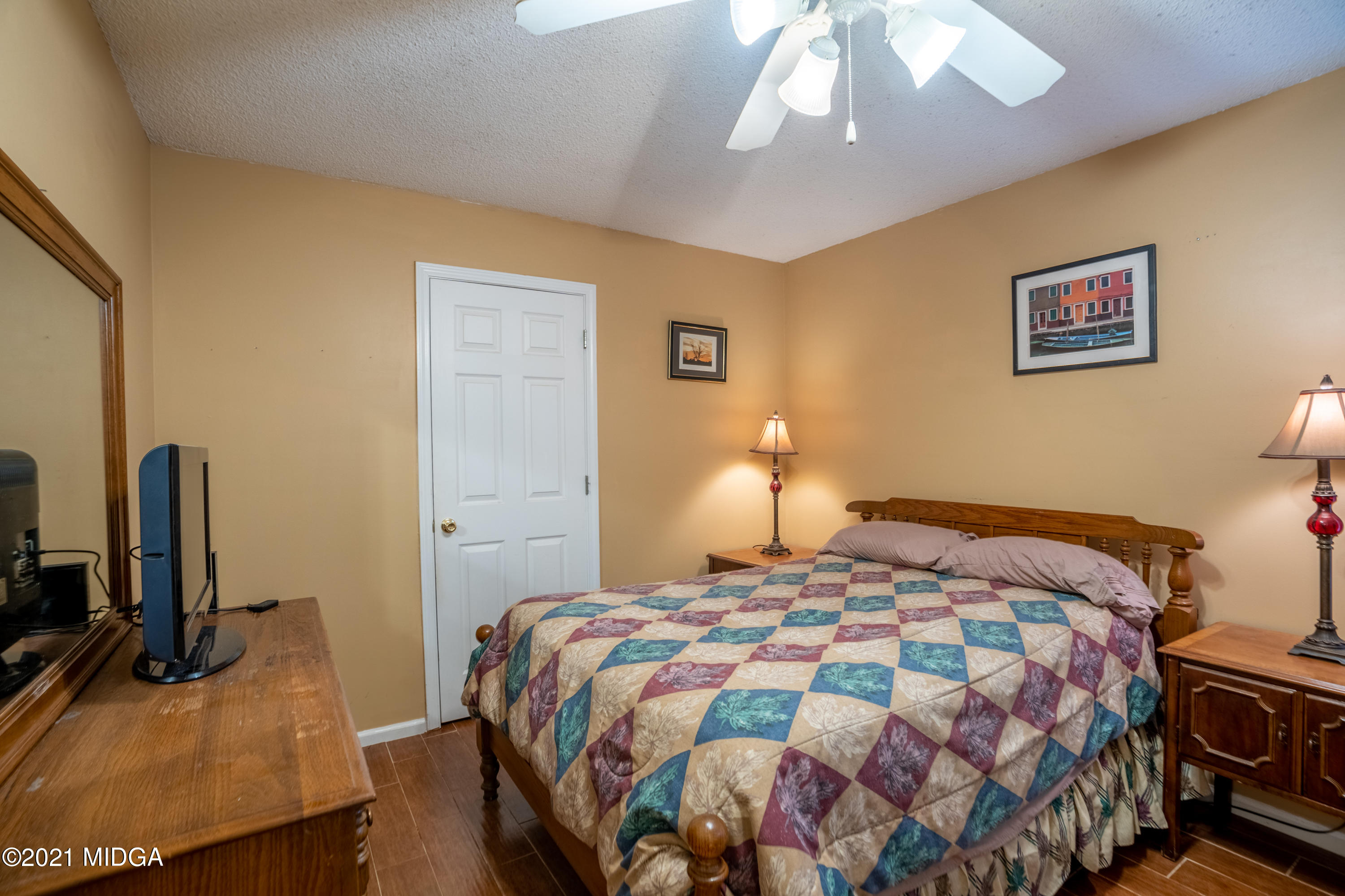 208 Camelot Road Gray, GA 31032 - Photo 25 of 41 a bedroom with a bed and a flat screen tv
