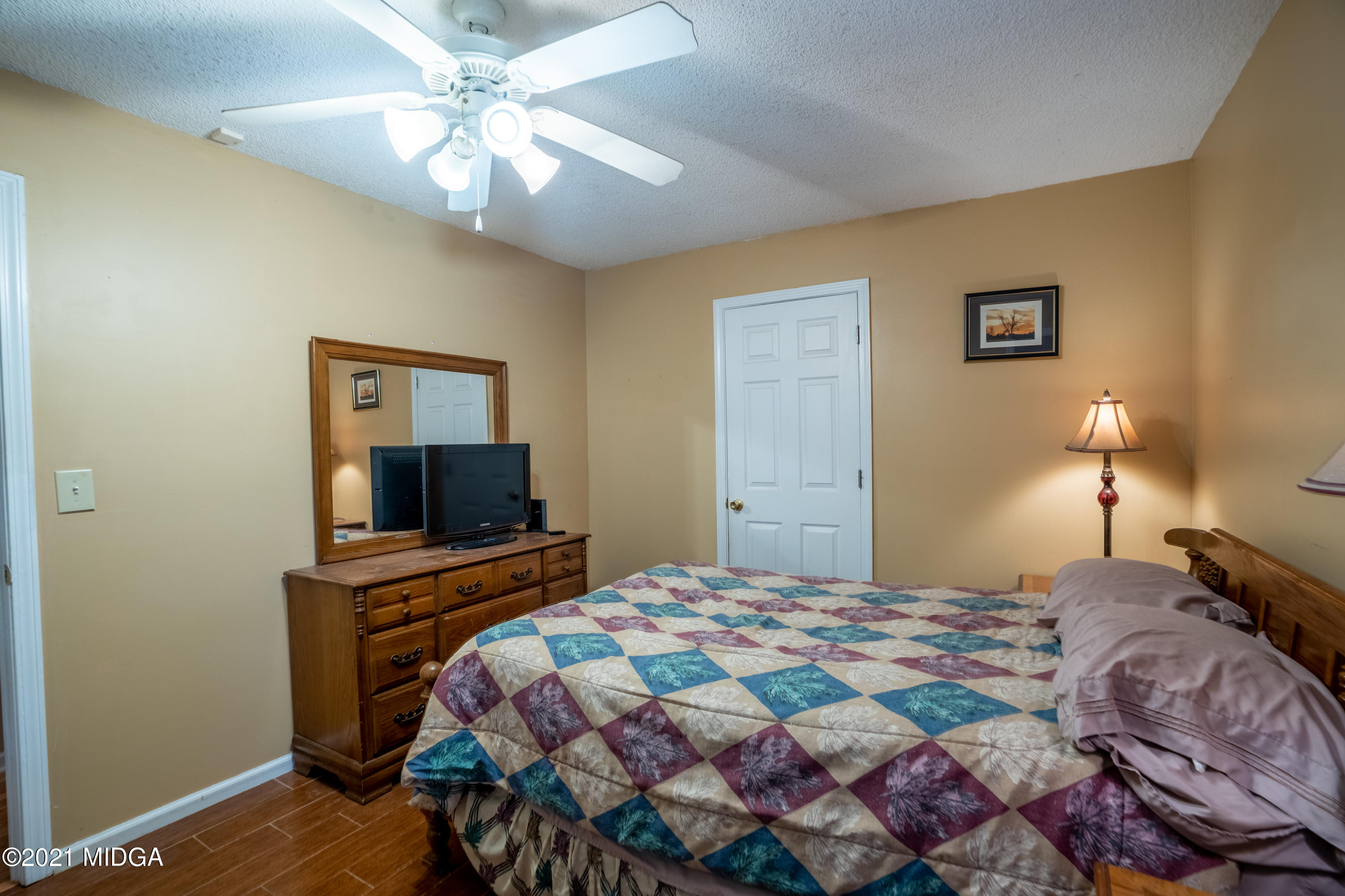 208 Camelot Road Gray, GA 31032 - Photo 27 of 41 a bedroom with a bed and a flat screen tv