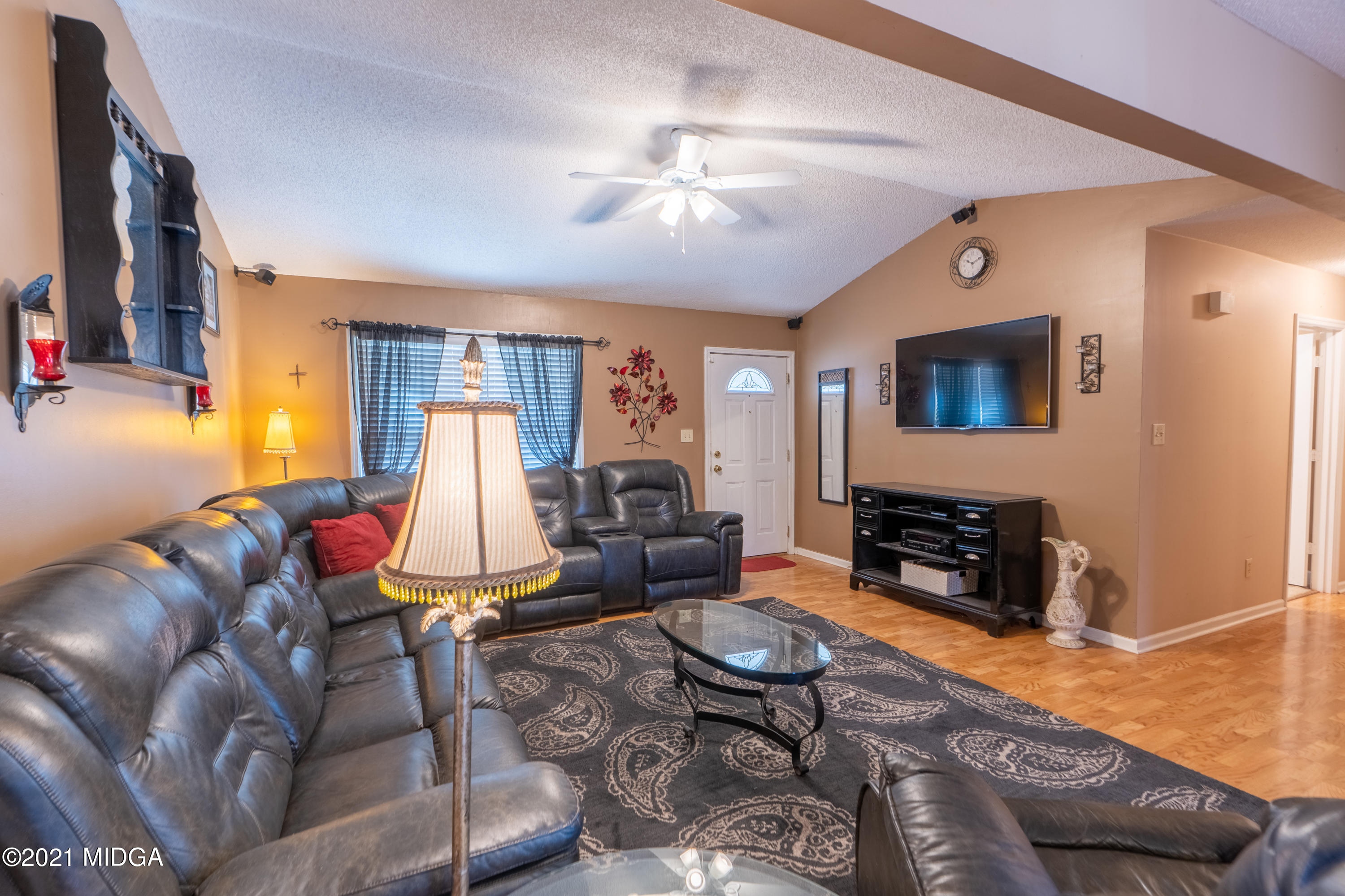 208 Camelot Road Gray, GA 31032 - Photo 5 of 41 a living room with furniture a rug and a flat screen tv