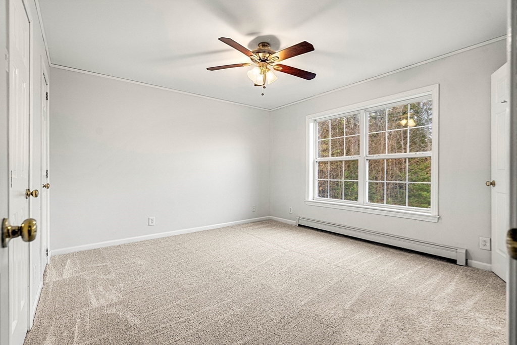 454 Little Pond Road Sandwich, NH 03227 - Photo 15 of 38 an empty room with window and ceiling fan