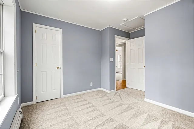 a bedroom with a bed and a mirror