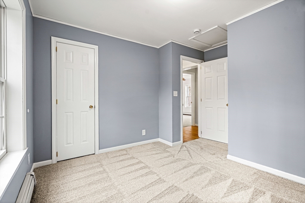 454 Little Pond Road Sandwich, NH 03227 - Photo 19 of 38 a bedroom with a bed and a mirror