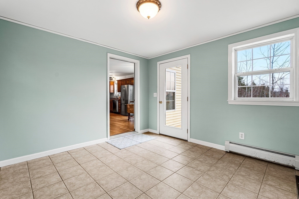 454 Little Pond Road Sandwich, NH 03227 - Photo 25 of 38 a view of an empty room with window and hardwood floor