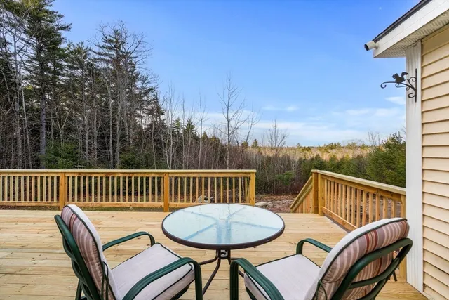 a view of a chair and table on the deck