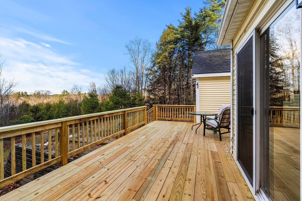 454 Little Pond Road Sandwich, NH 03227 - Photo 6 of 38 a view of balcony with wooden floor and seating