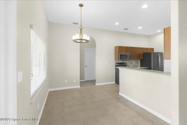 a kitchen with stainless steel appliances granite countertop a sink and dishwasher a stove top oven with wooden floor