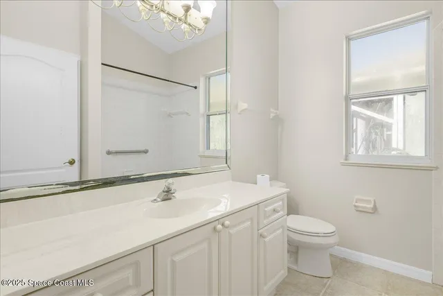 an empty room with a fan & a ceiling fan