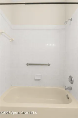 a bathroom with a shower and a sink