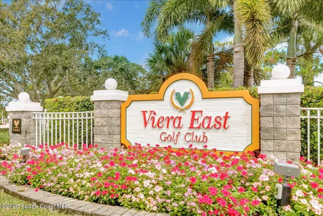 a view of a white house with a yard