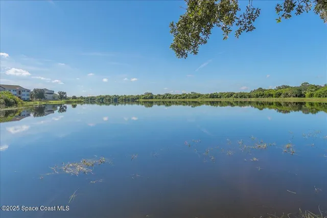 a view of a lake with houses in the back