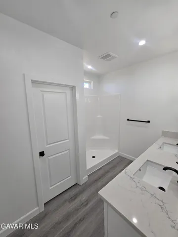 a bathroom with a sink and shower