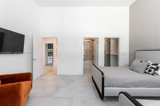 a bedroom with two beds and a window