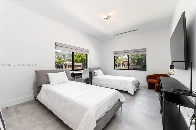 a view of a dining room with furniture a chandelier and wooden floor