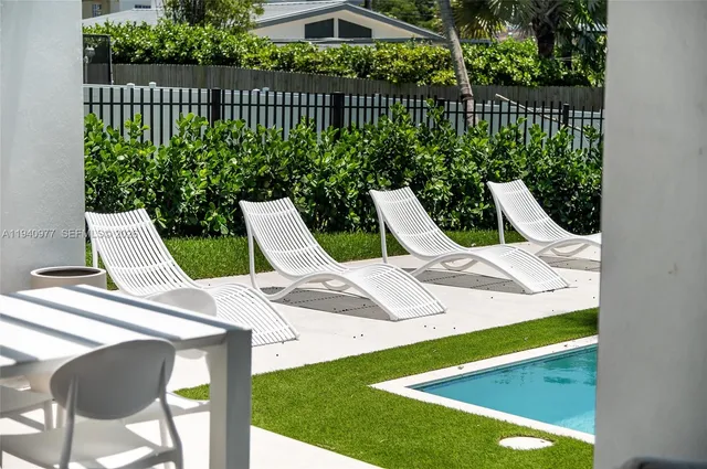 a aerial view of a house with a yard and potted plants