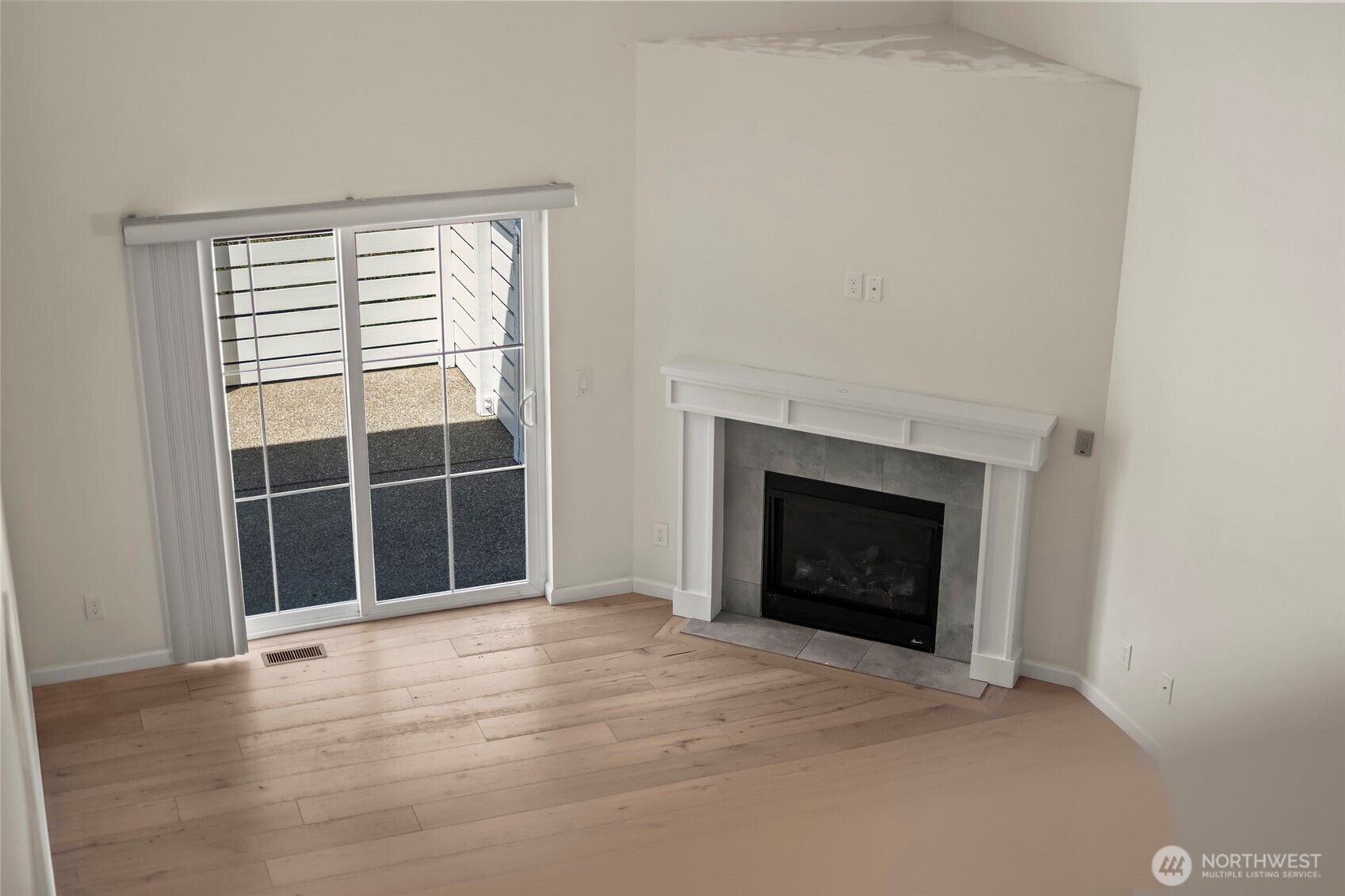 1080 East Old Ranch Road, Unit A1A2 Allyn, WA 98524 - Photo 33 of 35 a view of an empty room with wooden floor and a window