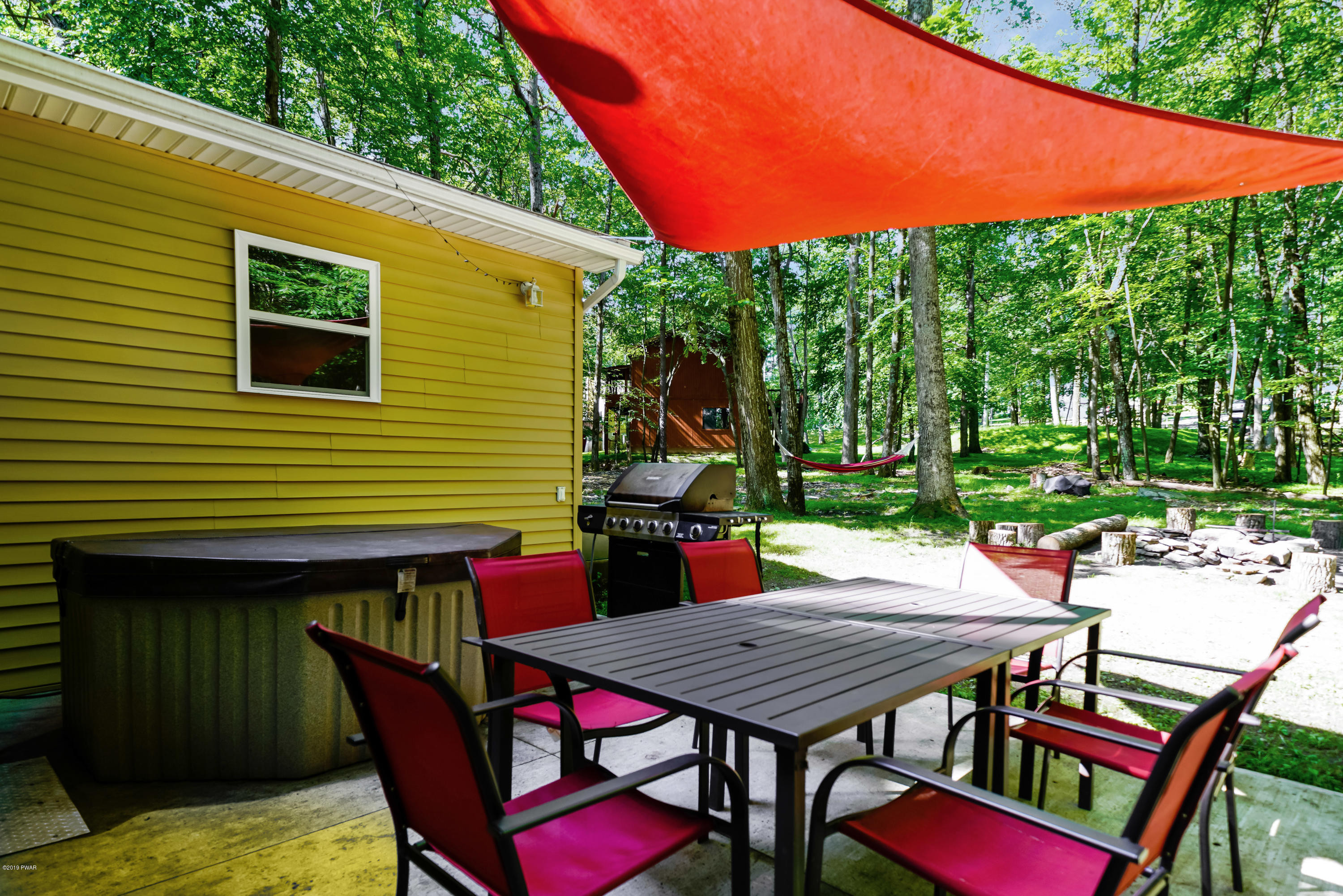 176 Gold Key Road Milford, PA 18337 - Photo 24 of 27 a view of a patio with table and chairs under an umbrella