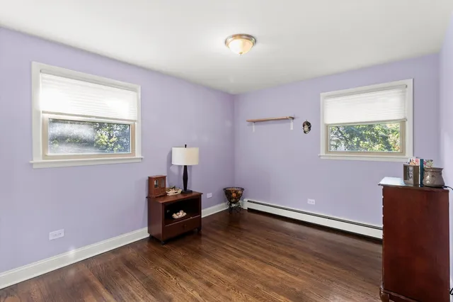 a room with wooden floor and a window