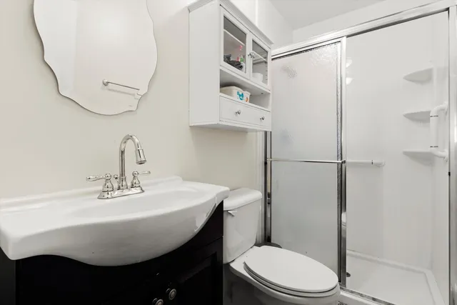a bathroom with a sink toilet and shower