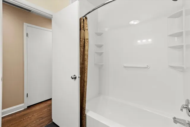 a bathroom with a bathtub and a shower