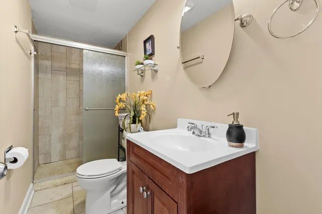 a bathroom with a sink vanity mirror and toilet