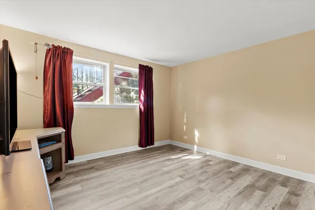 a view of a room with window and wooden floor