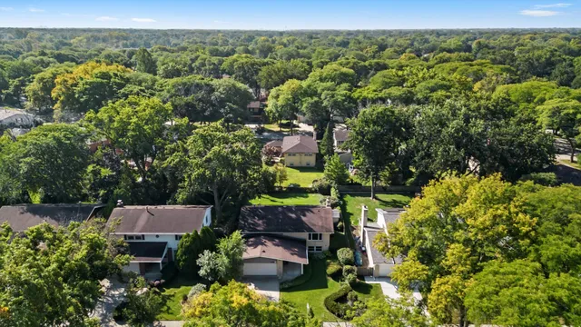 an aerial view of a house with lots of trees