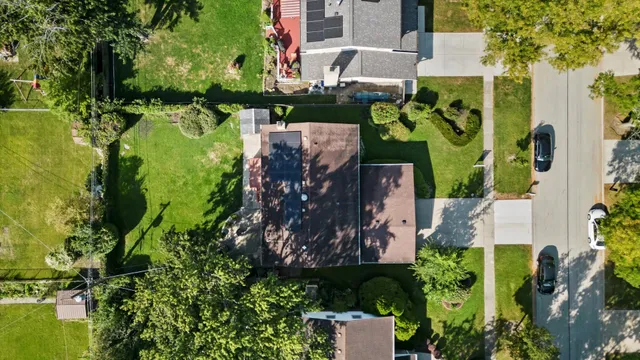 an aerial view of a house with a yard basket ball court and outdoor seating