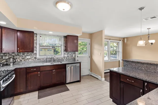 a kitchen with granite countertop a sink and cabinets